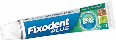 Denture adhesive tube from Fixodent Plus Dual Protection for secure fit and freshness, shown in a close-up image.