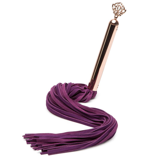 Fifty Shades Freed Cherished Collection suede flogger with leather handle, pink and black suede strands, and textured grip.