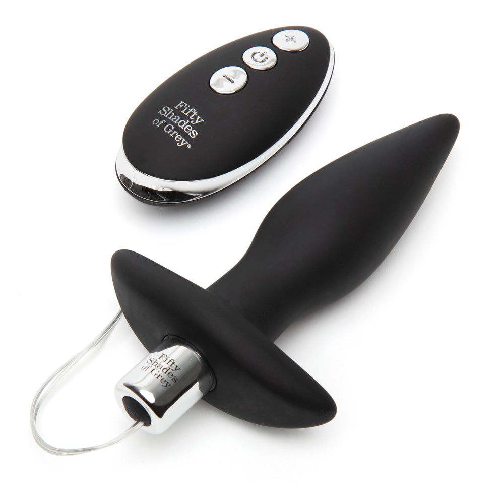Fifty Shades of Grey Relentless Vibrations remote control butt plug in black, showing smooth silicone surface and remote device.