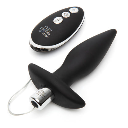 Fifty Shades of Grey Relentless Vibrations remote control butt plug in black, showing smooth silicone surface and remote device.