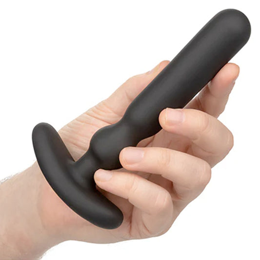 Hand holding a COLT Rechargeable Large Anal-T, showcasing its size and design for adult pleasure and insertion.