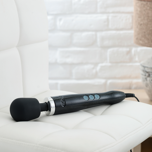 Black Doxy Die Cast vibrator with textured surface and ergonomic design, showcasing its sleek, metallic finish.
