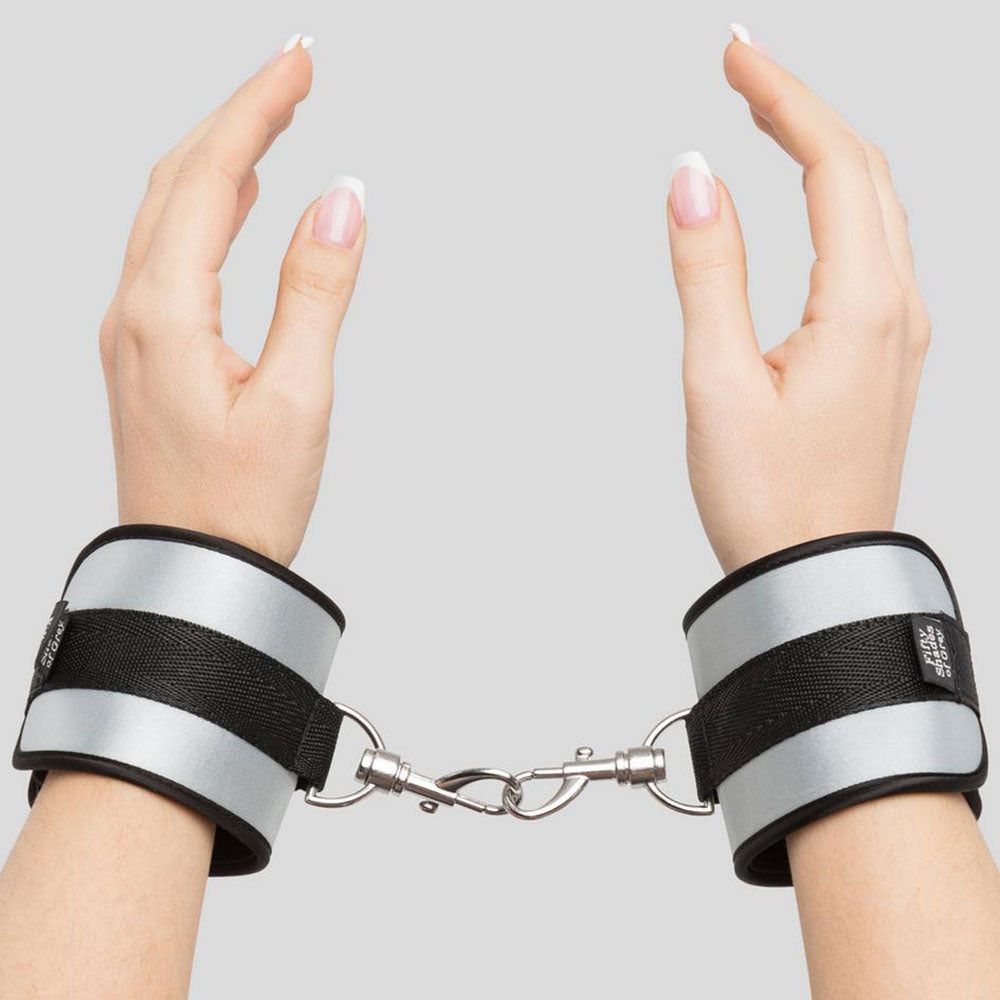 Fifty Shades of Grey Hard Limits Bed Restraint Kit with adjustable straps and cuffs on a bed for BDSM restraint play.