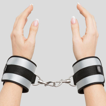 Fifty Shades of Grey Hard Limits Bed Restraint Kit with adjustable straps and cuffs on a bed for BDSM restraint play.