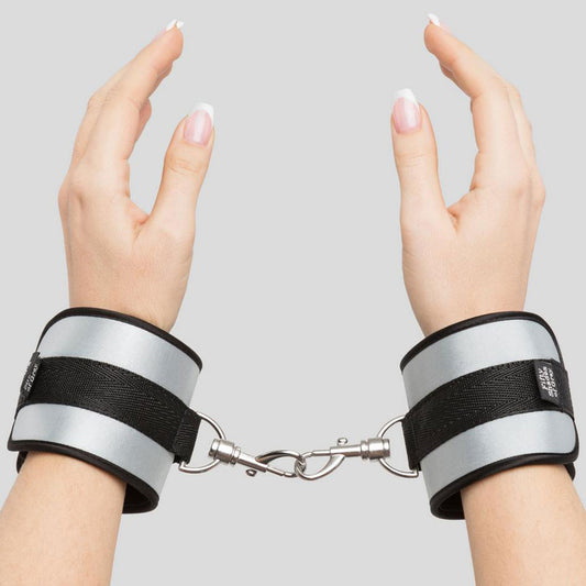 Fifty Shades of Grey Hard Limits Bed Restraint Kit with adjustable straps and cuffs on a bed for BDSM restraint play.