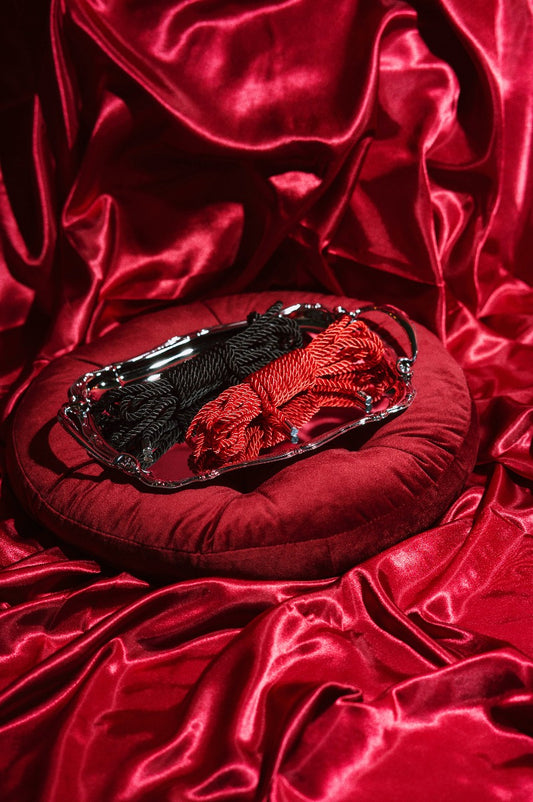 Fifty Shades of Grey Restrain Me bondage ropes twin pack with black and red ropes, textured fabric and metal clasps for restraint.