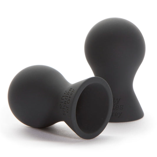 Fifty Shades of Grey Nothing but Sensation Nipple Teasers in black, shown with adjustable straps and metal accents on a white background.