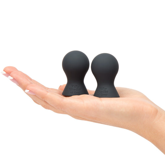 Fifty Shades of Grey Nothing but Sensation Nipple Teasers in black, featuring sleek, soft silicone design for sensual stimulation.