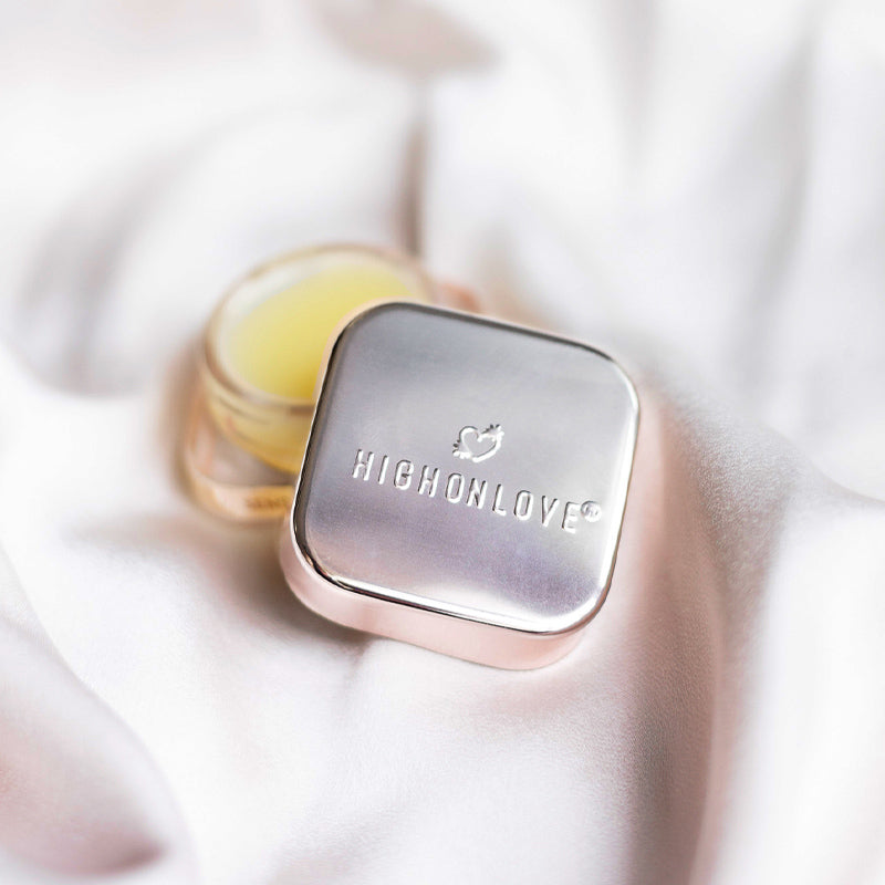 Limited edition High On Love sensual lip balm in a sleek container, showcasing its smooth, moisturizing texture.