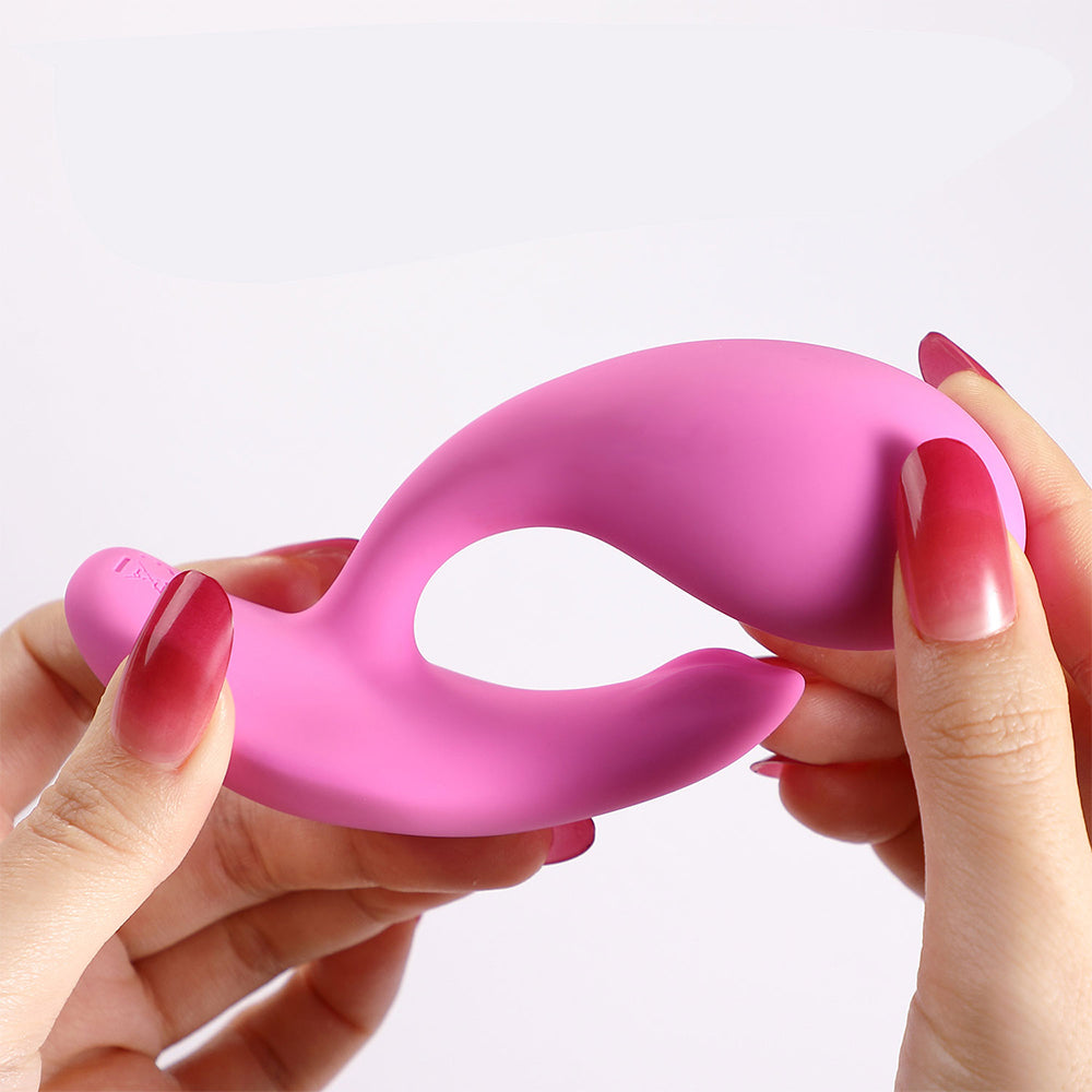 Honey Play Box Oly 2 wearable vibrator in pale pink, shown in hand, with app-enabled pressure sensing for clitoral and G-spot stimulation.